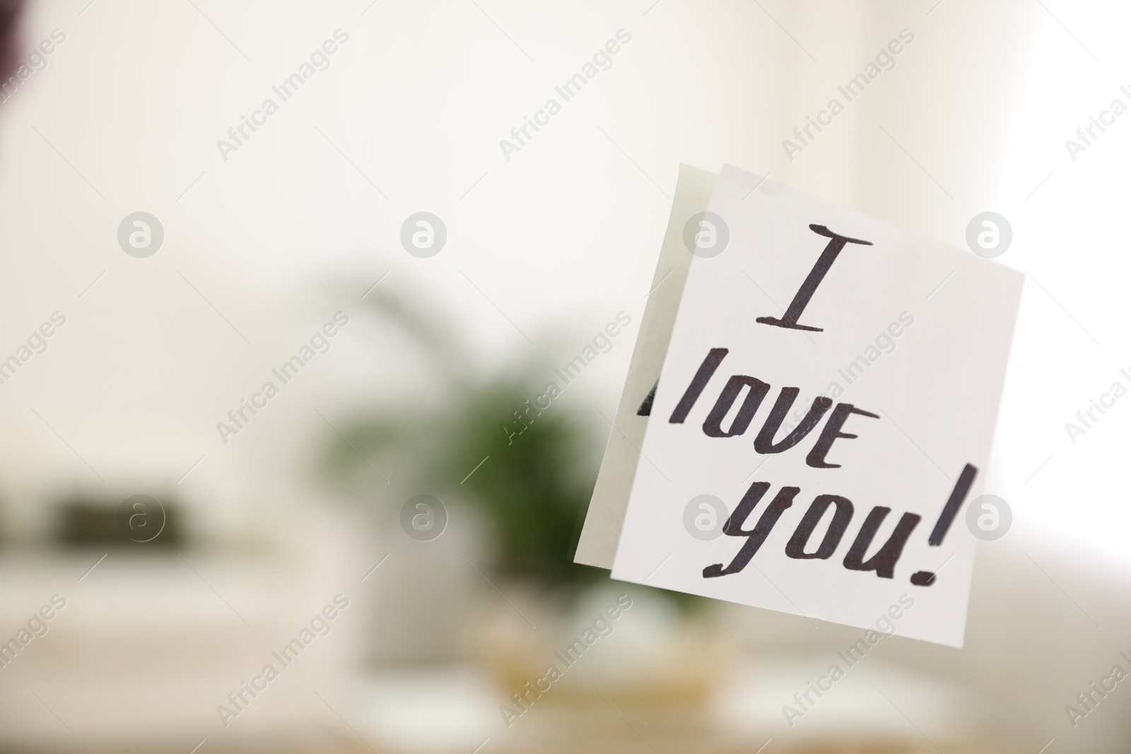 Photo of Paper note with handwritten words I Love You on mirror indoors