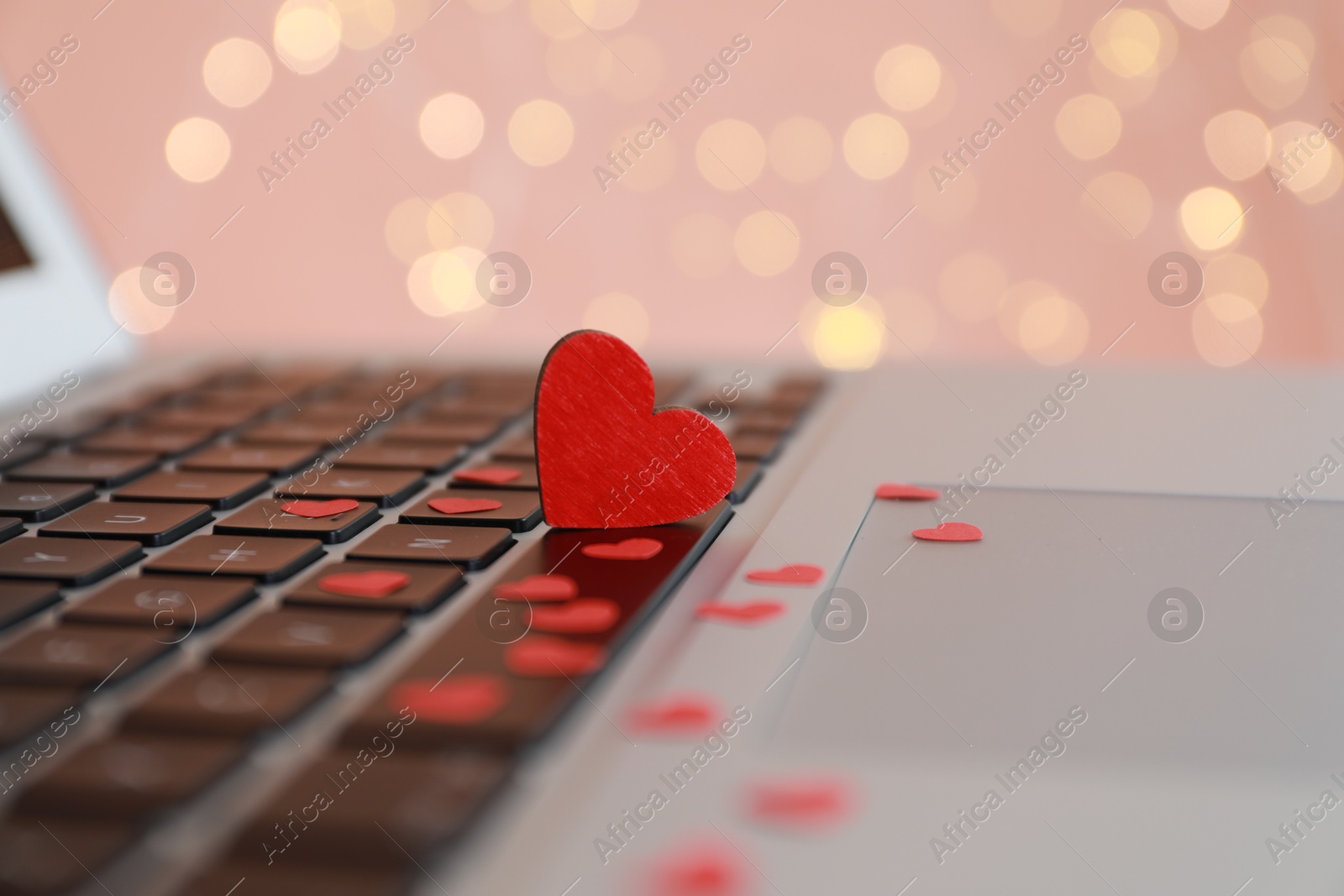 Photo of Hearts on laptop keyboard, closeup. Online dating concept