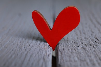 Photo of Red decorative heart on grey wooden table, closeup