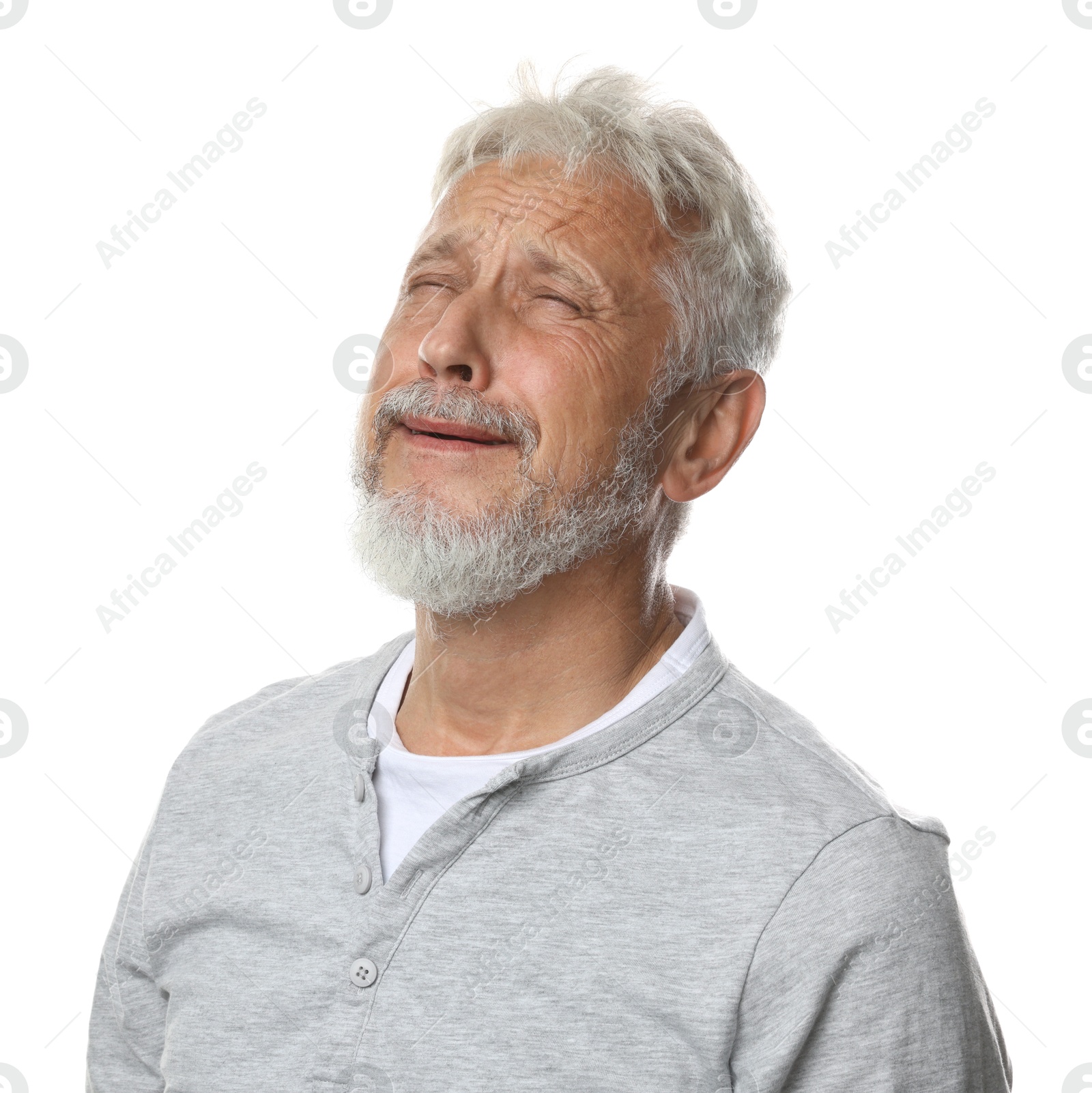 Photo of Sad senior man crying on white background