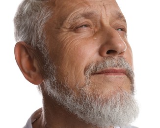 Photo of Sad senior man crying on white background, closeup