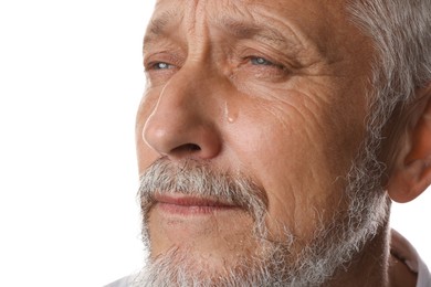 Photo of Sad senior man crying on white background, closeup