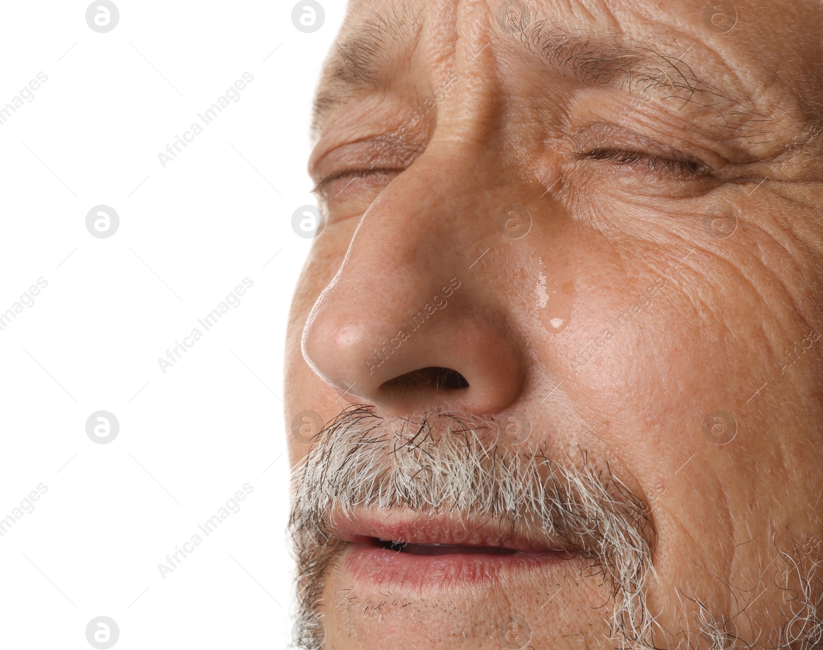 Photo of Sad senior man crying on white background, closeup