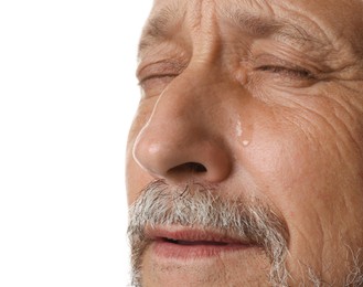 Photo of Sad senior man crying on white background, closeup