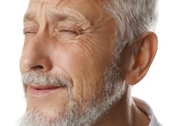 Photo of Sad senior man crying on white background, closeup