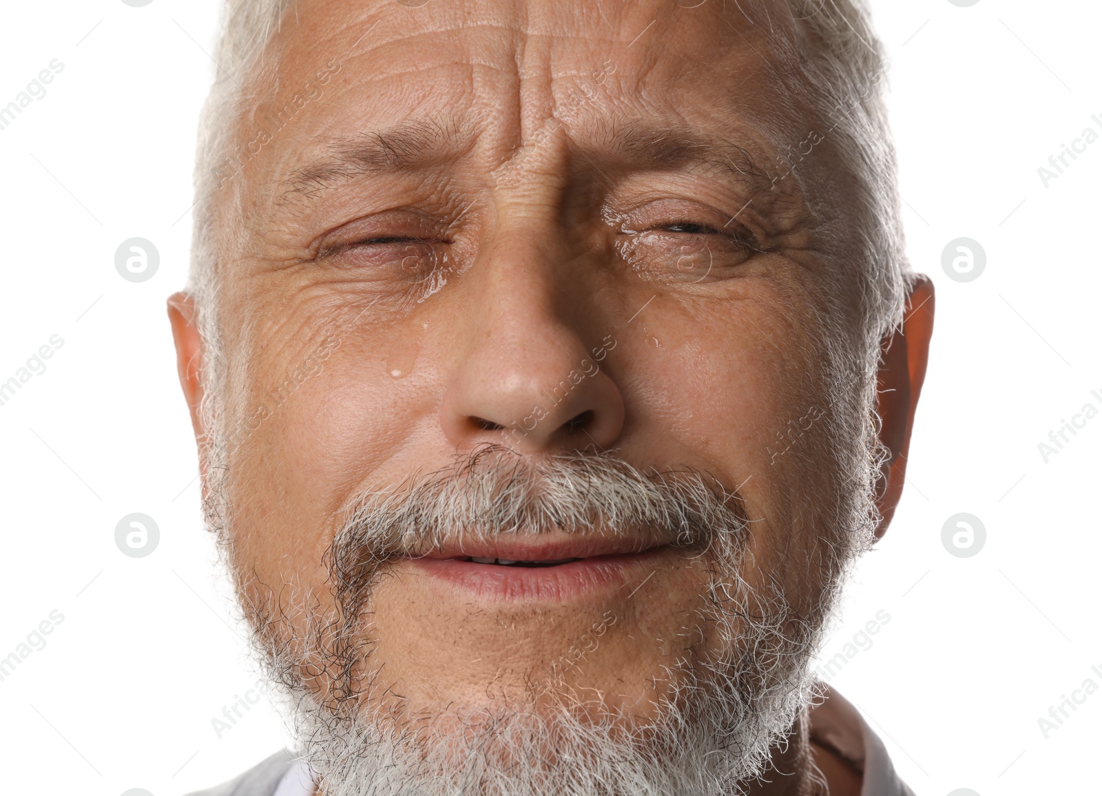 Photo of Sad senior man crying on white background, closeup