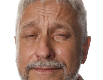 Photo of Sad senior man crying on white background, closeup