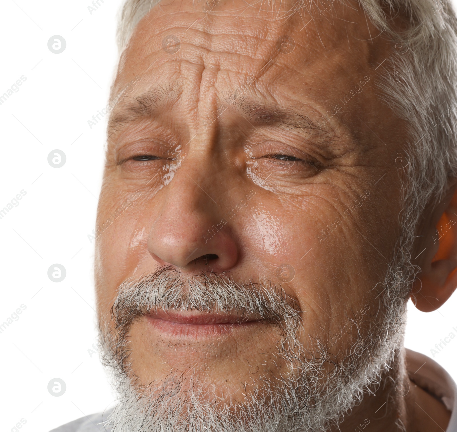 Photo of Sad senior man crying on white background, closeup