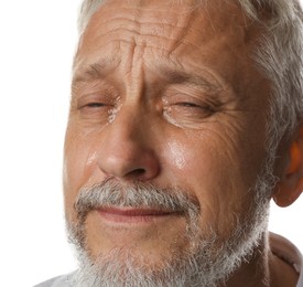 Photo of Sad senior man crying on white background, closeup