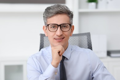 Photo of Portrait of businessman with glasses in office