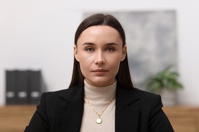 Photo of Portrait of businesswoman in jacket at workplace