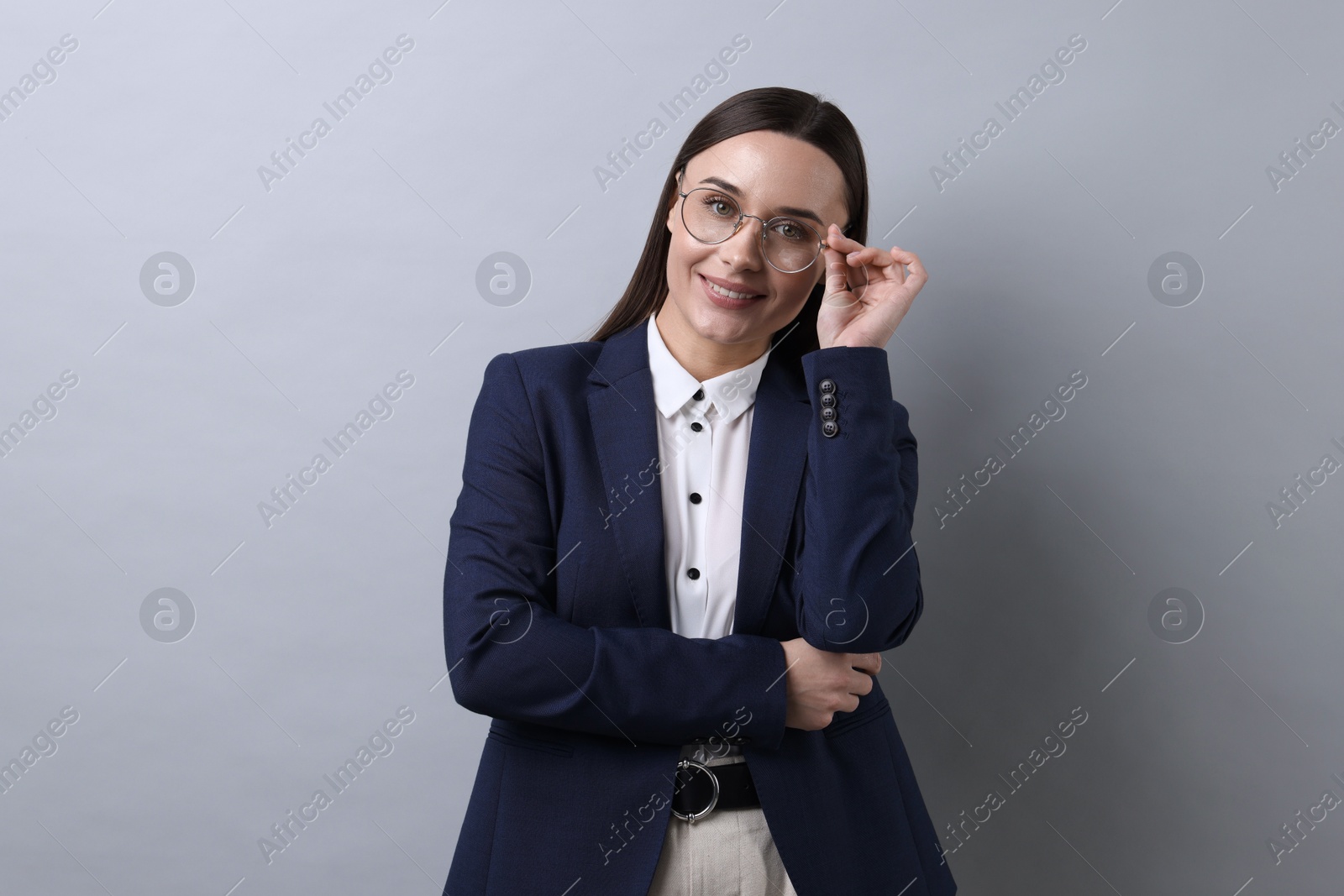 Photo of Portrait of businesswoman in glasses on light grey background