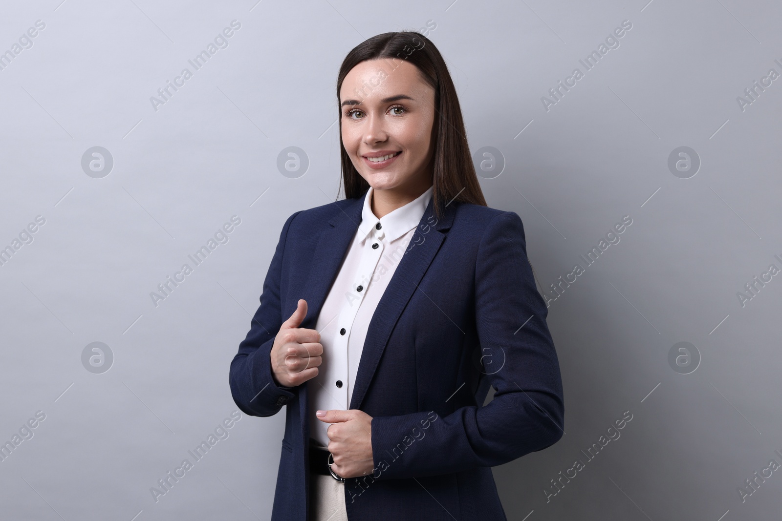 Photo of Portrait of businesswoman on light grey background