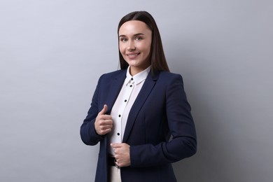 Photo of Portrait of businesswoman on light grey background