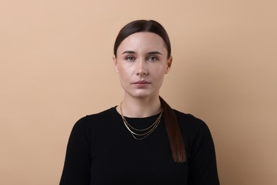 Photo of Portrait of beautiful businesswoman on beige background