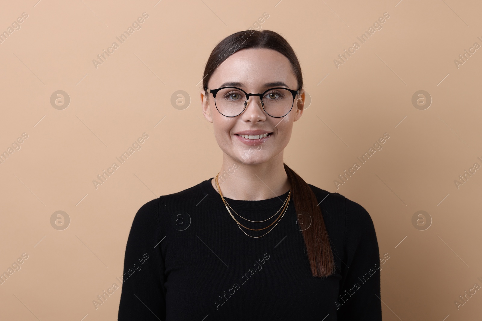 Photo of Portrait of businesswoman in glasses on beige background