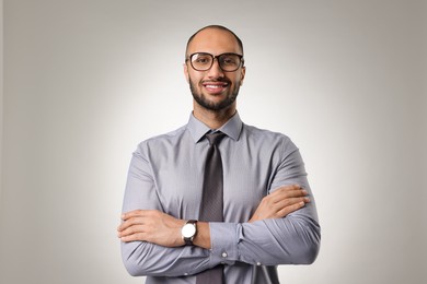 Portrait of businessman in glasses on light gray background