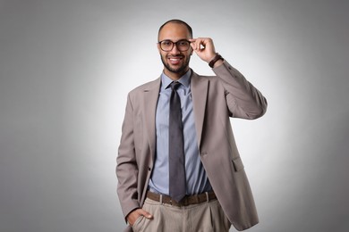 Photo of Portrait of businessman in glasses on light gray background