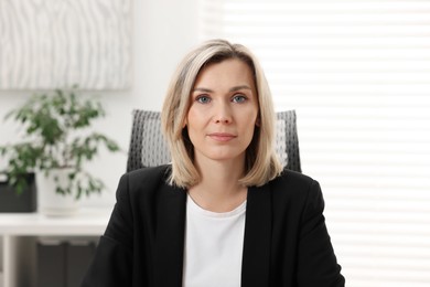 Photo of Portrait of beautiful businesswoman in jacket indoors