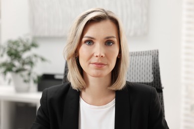 Portrait of beautiful businesswoman in jacket indoors