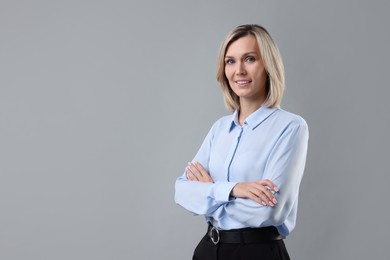 Photo of Portrait of businesswoman on gray background, space for text