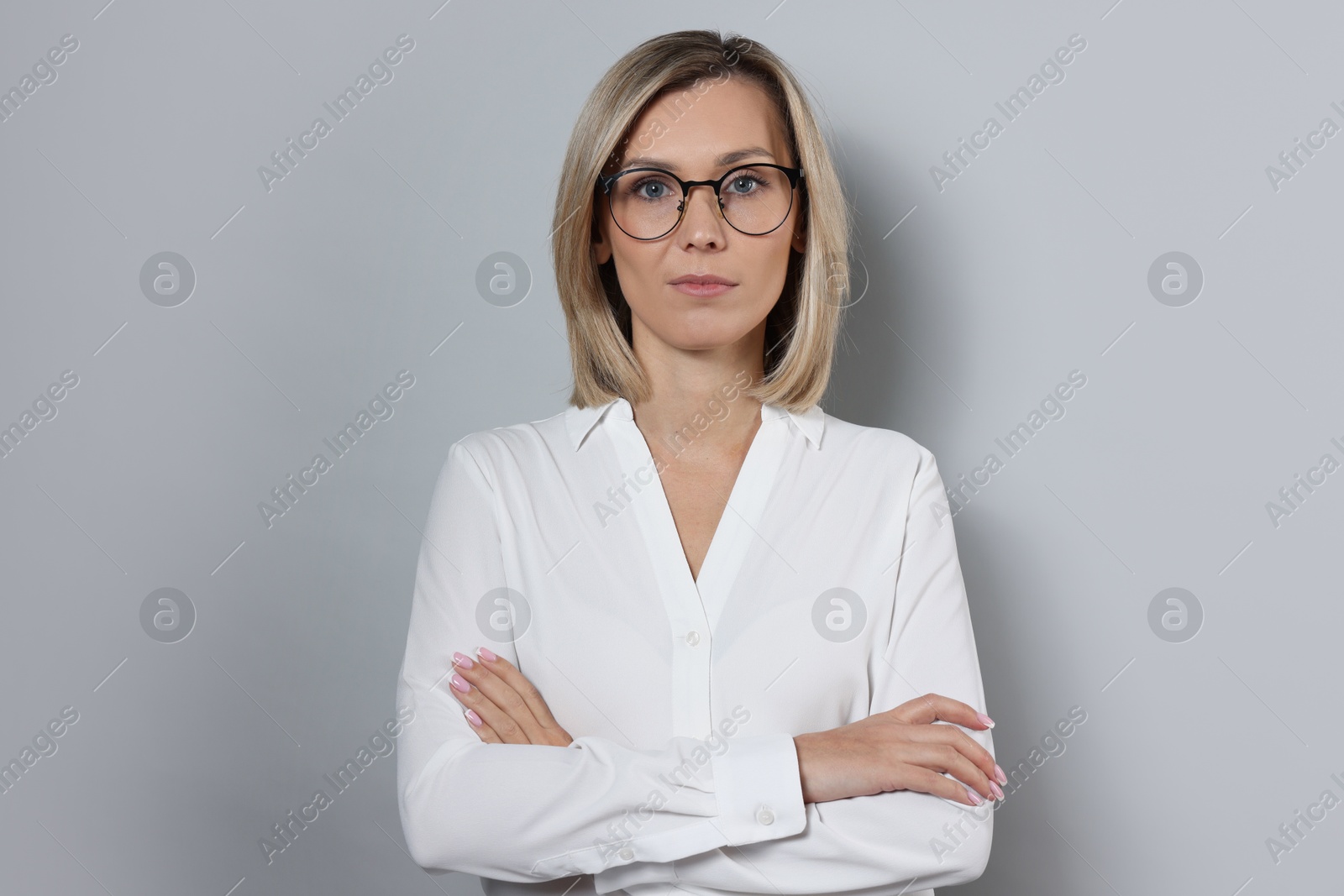 Photo of Portrait of businesswoman in glasses on gray background