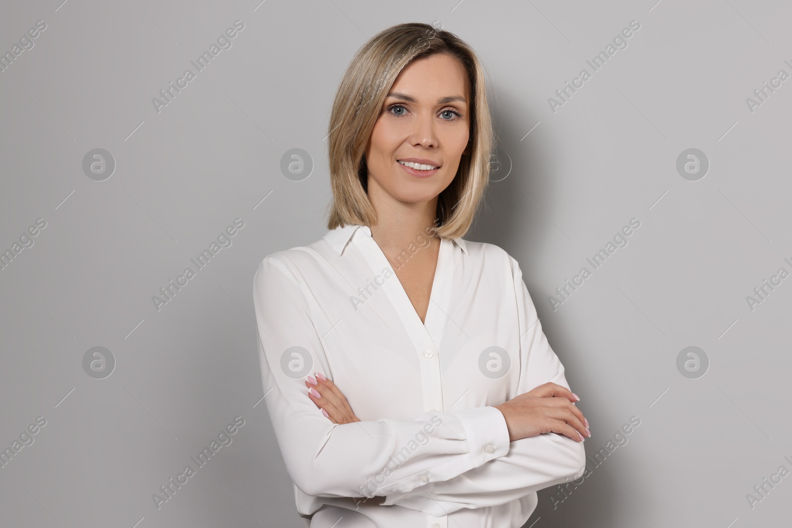 Photo of Portrait of businesswoman in white shirt on gray background