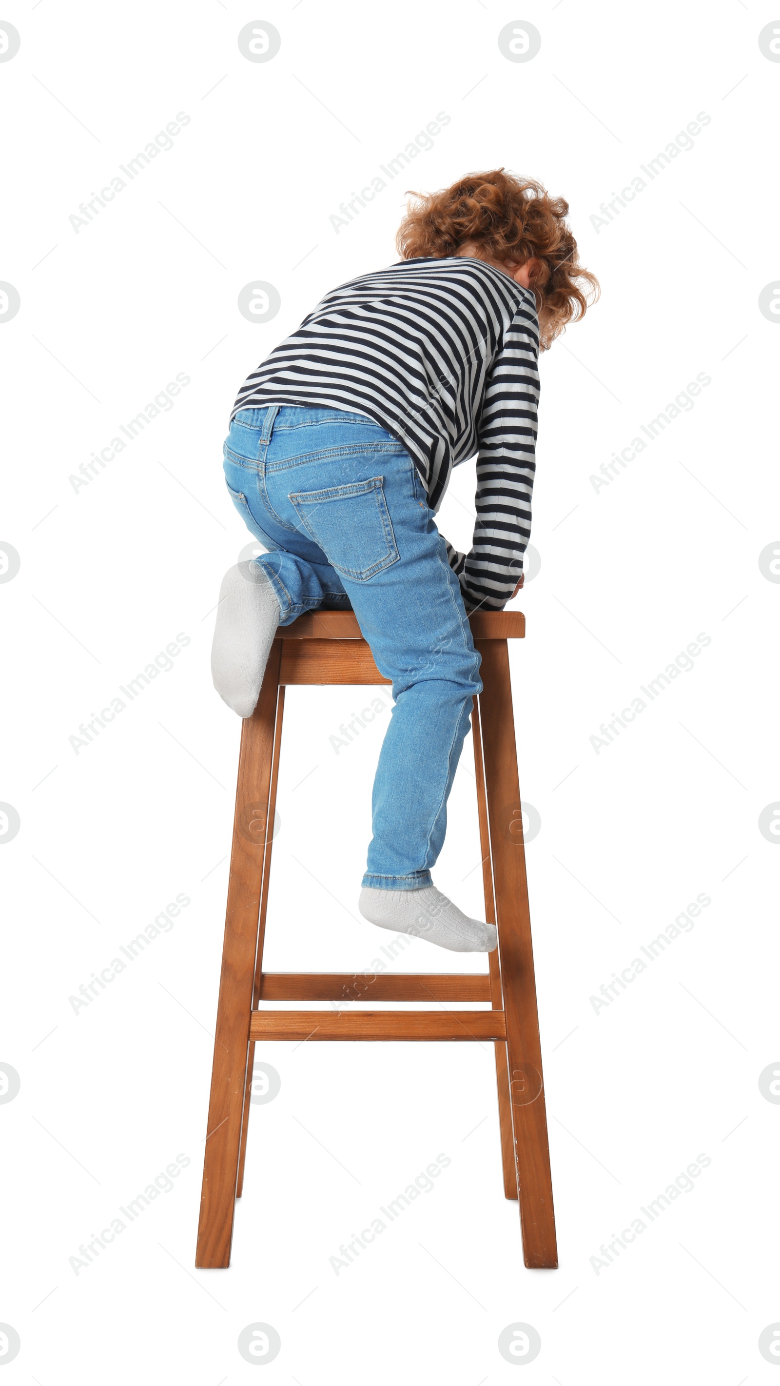 Photo of Little boy sitting on stool against white background