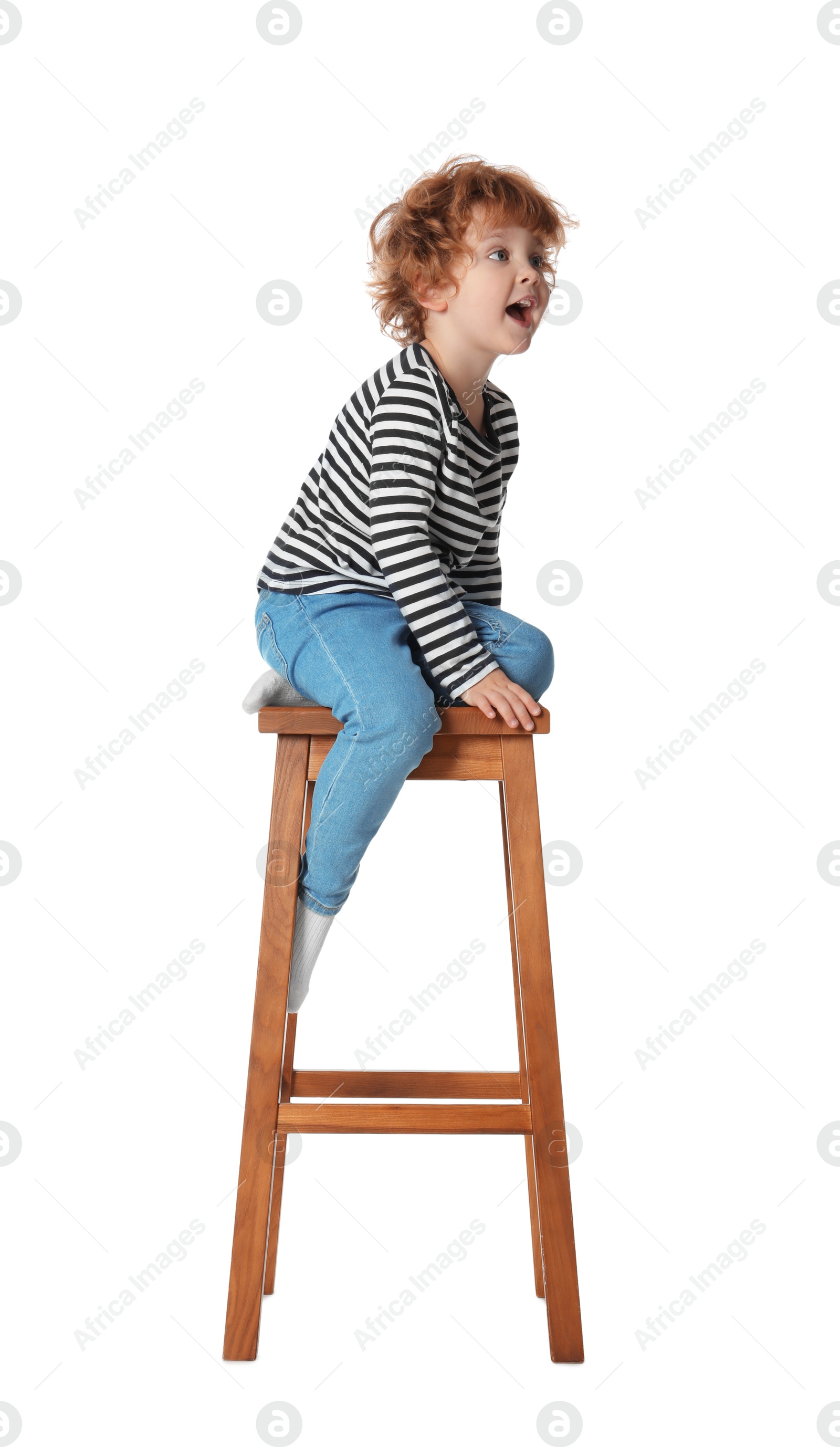 Photo of Little boy sitting on stool against white background