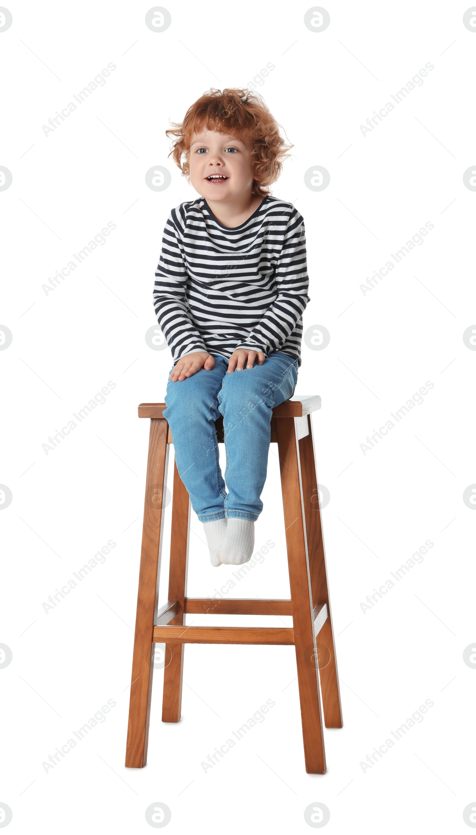 Photo of Little boy sitting on stool against white background