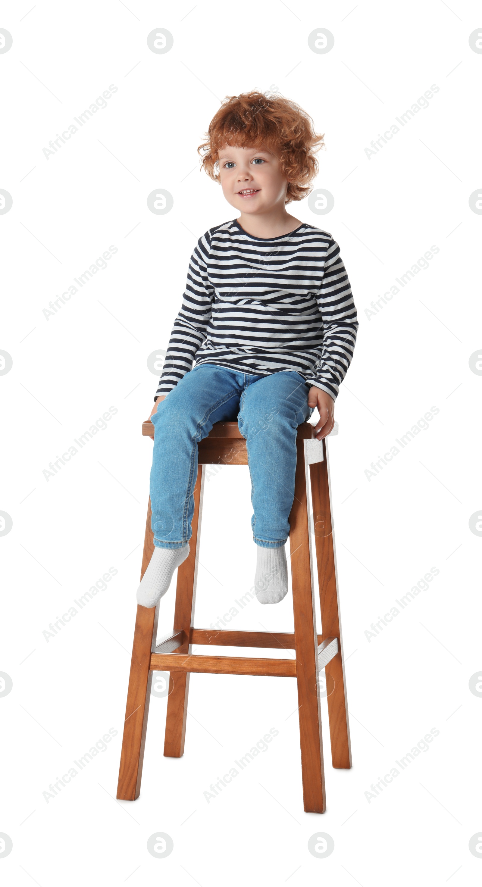 Photo of Little boy sitting on stool against white background