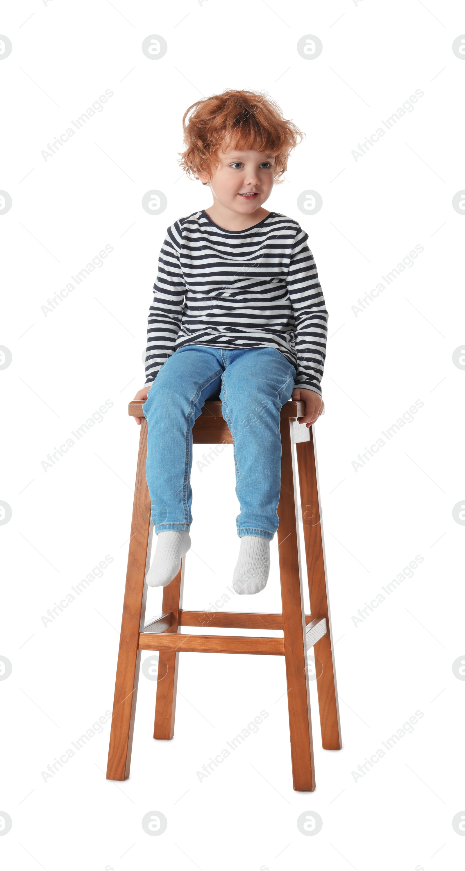 Photo of Little boy sitting on stool against white background