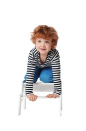 Photo of Little boy with step stool on white background