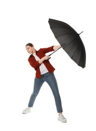 Photo of Young woman with black umbrella on white background