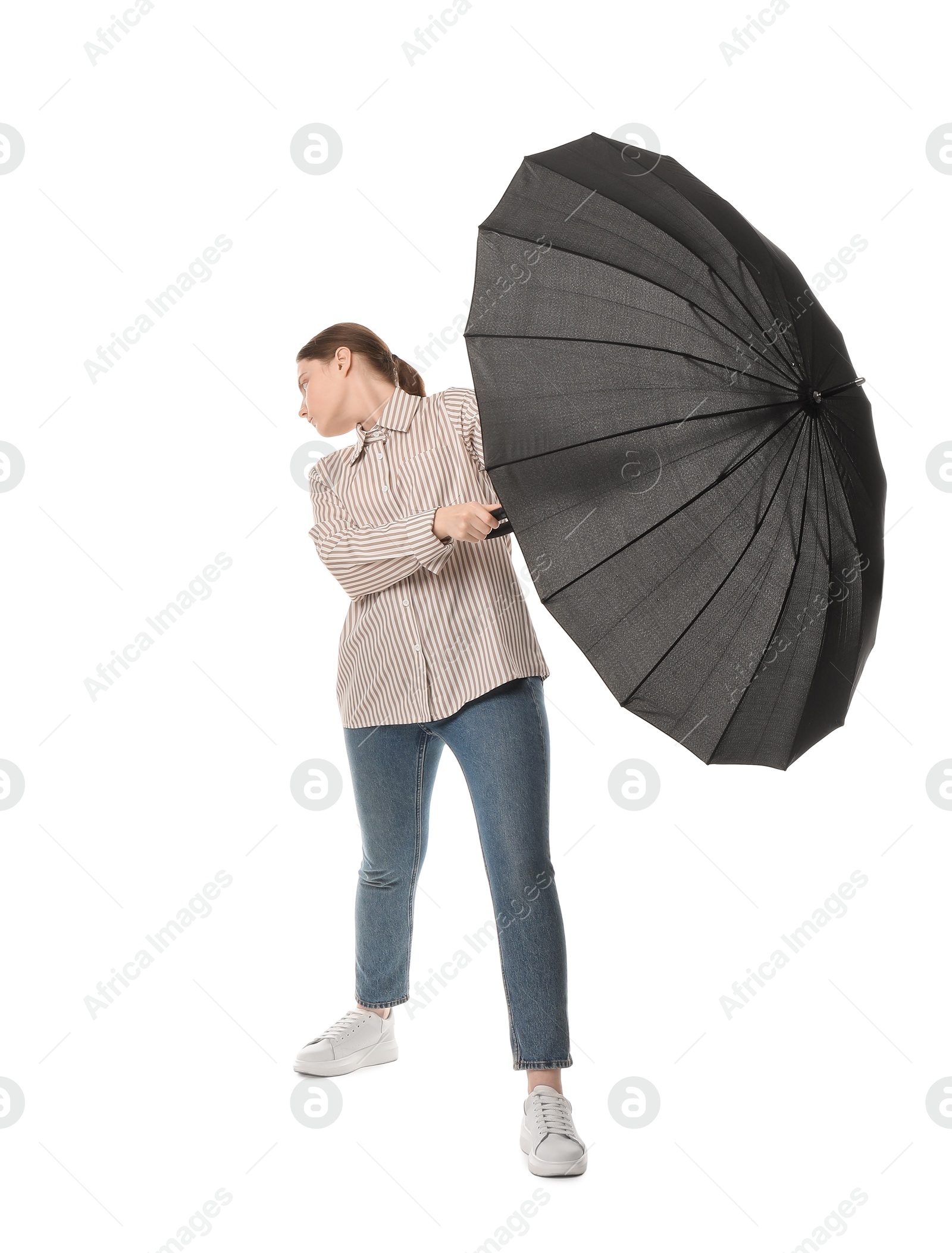 Photo of Young woman with black umbrella on white background