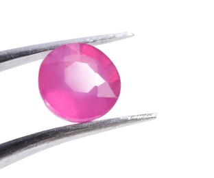 Photo of Tweezers with shiny pink gemstone isolated on white