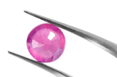 Photo of Tweezers with shiny pink gemstone isolated on white