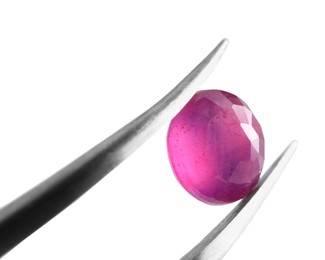 Photo of Tweezers with shiny pink gemstone isolated on white