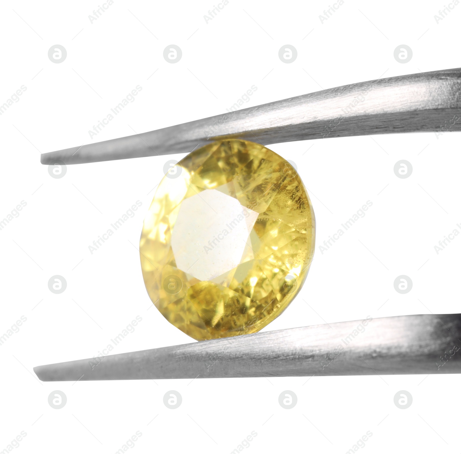 Photo of Tweezers with shiny yellow gemstone isolated on white