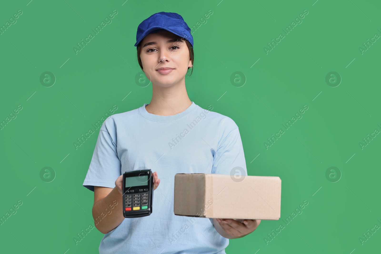 Photo of Girl in uniform with parcel and payment terminal on green background. Work for teenagers