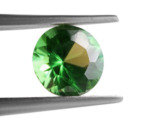 Photo of Tweezers with shiny green gemstone isolated on white