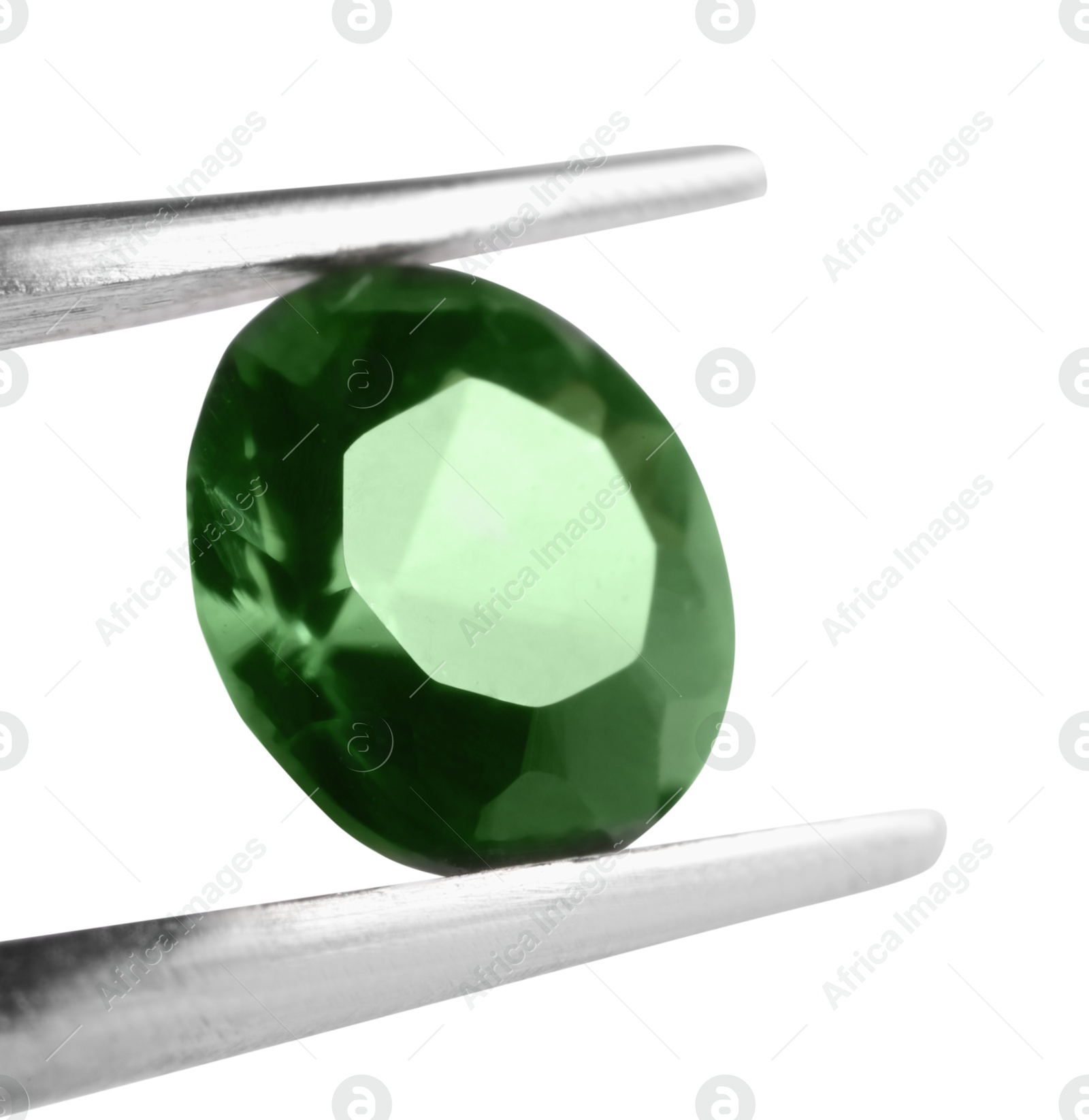 Photo of Tweezers with shiny green gemstone isolated on white