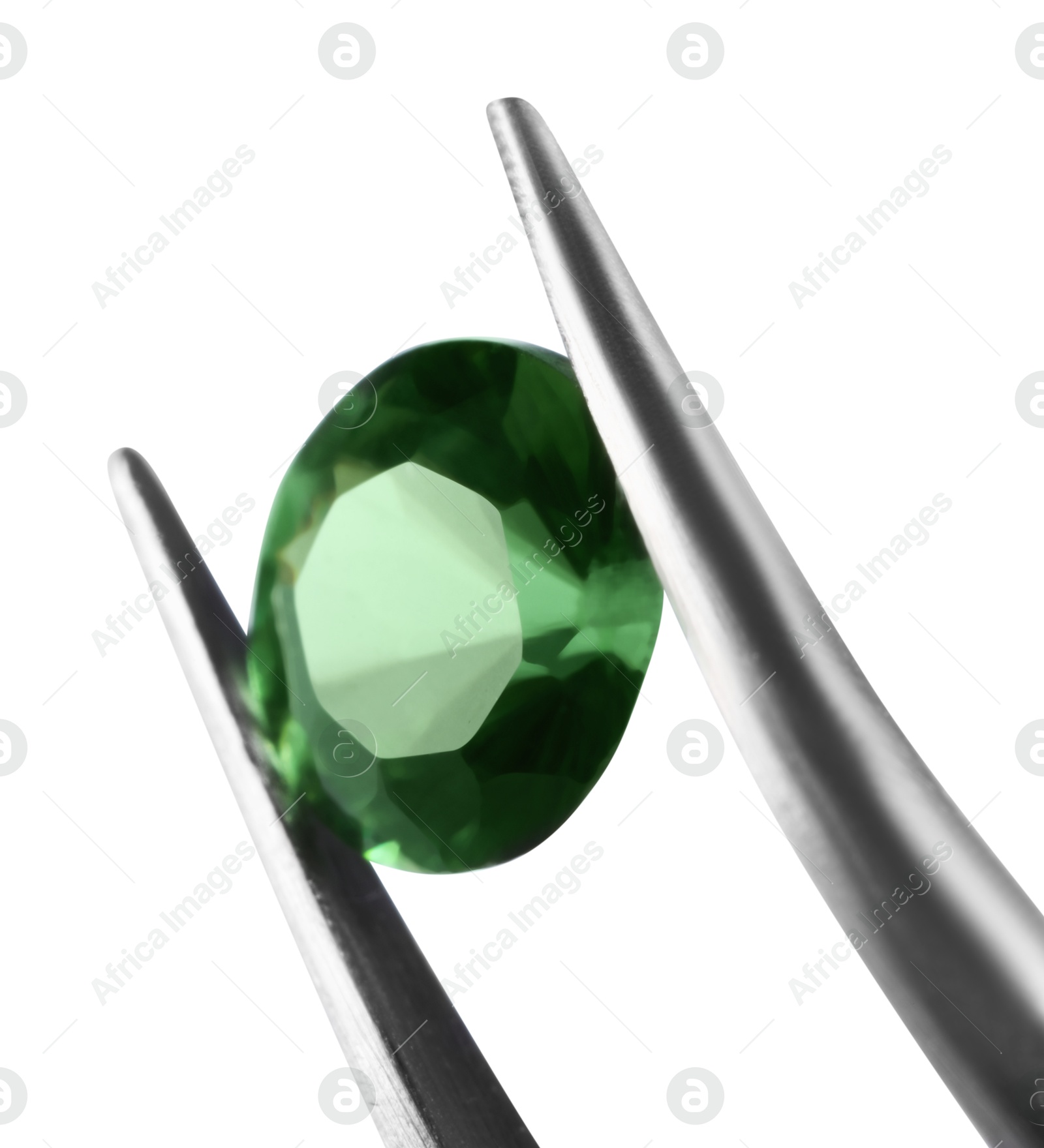 Photo of Tweezers with shiny green gemstone isolated on white