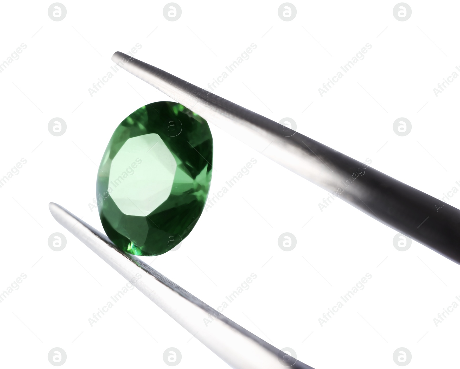 Photo of Tweezers with shiny green gemstone isolated on white