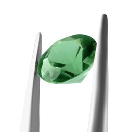 Photo of Tweezers with shiny green gemstone isolated on white