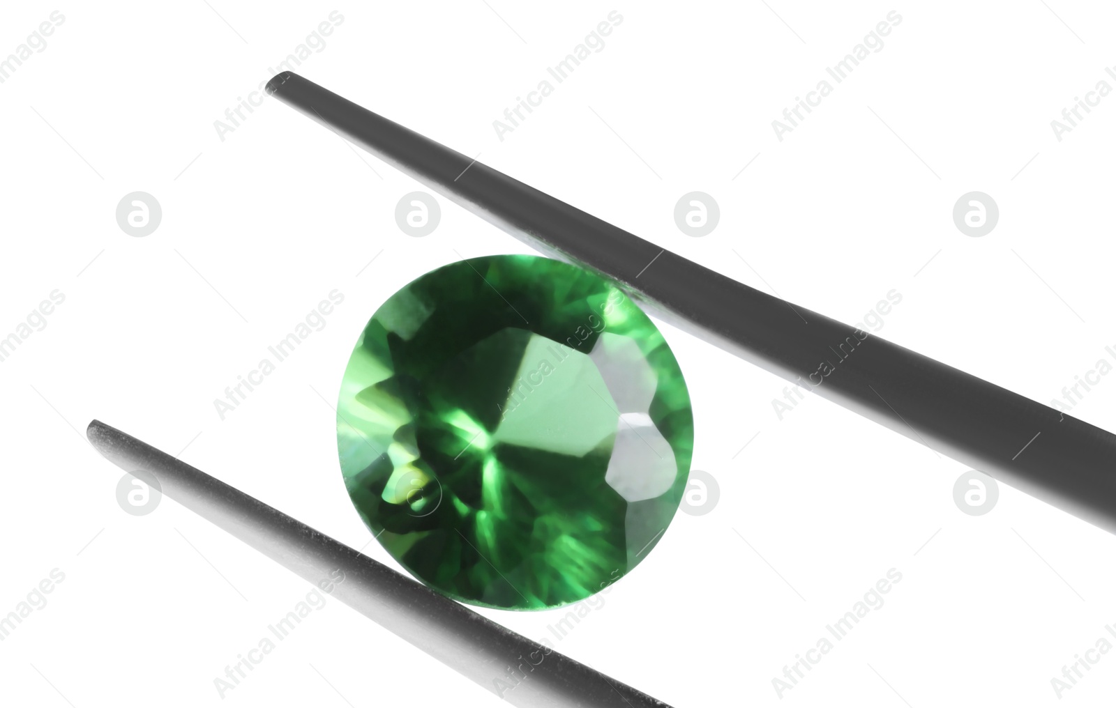 Photo of Tweezers with shiny green gemstone isolated on white