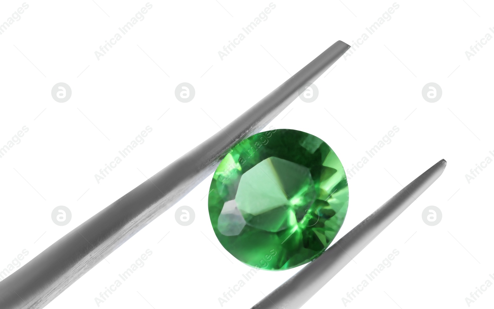 Photo of Tweezers with shiny green gemstone isolated on white