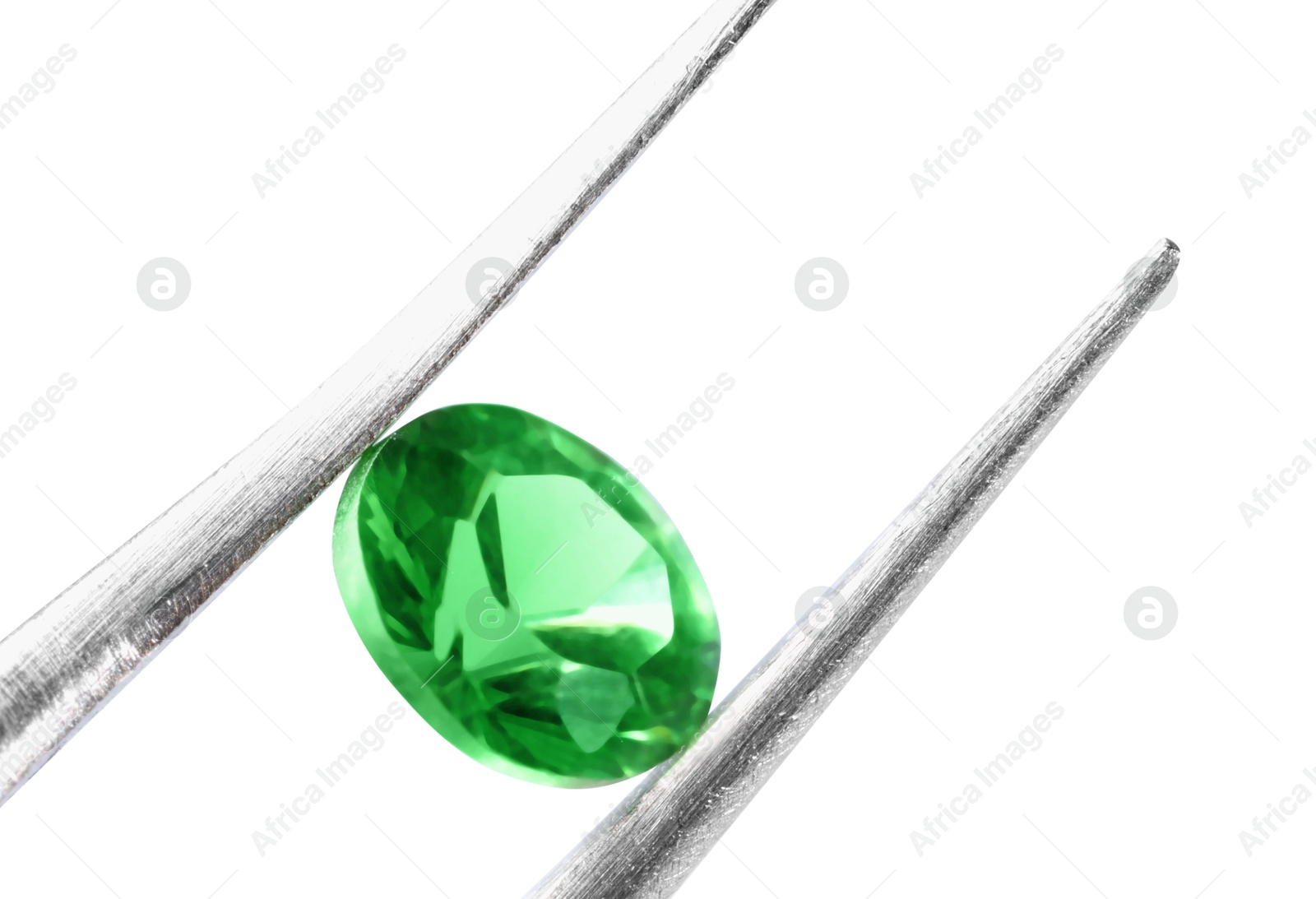 Photo of Tweezers with shiny green gemstone isolated on white