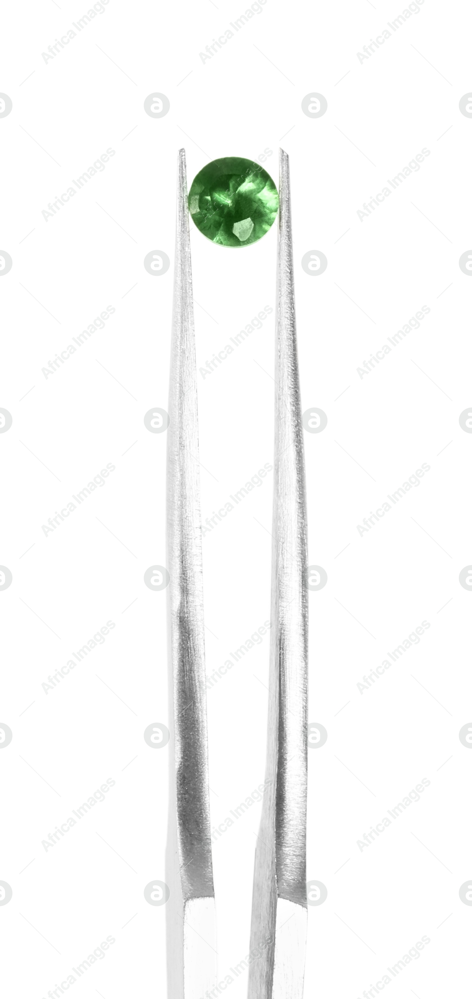 Photo of Tweezers with shiny green gemstone isolated on white