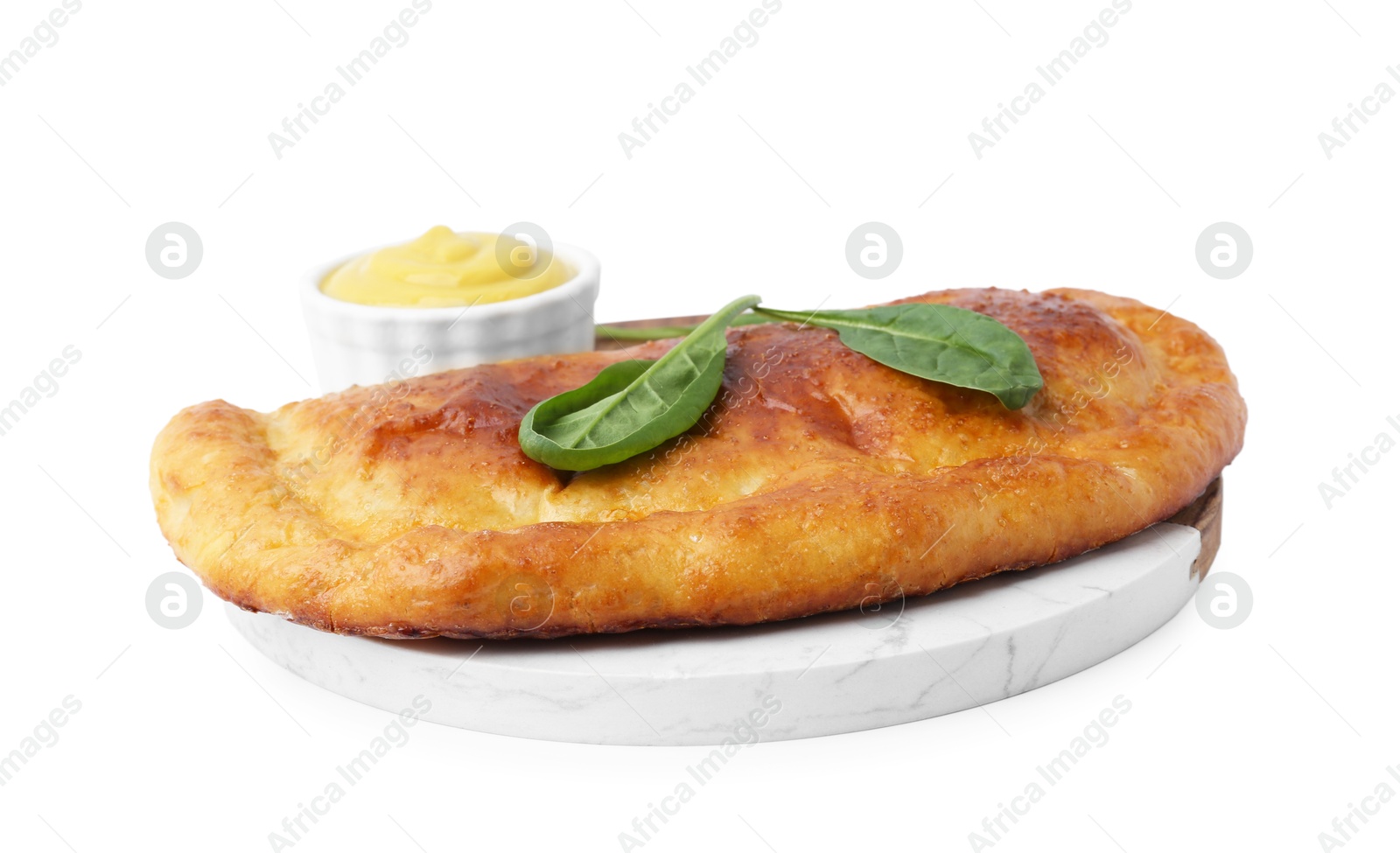 Photo of Tasty calzone with basil and sauce isolated on white